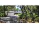 Two-story home with a large driveway and mature landscaping at 14815 Lake Pickett Rd, Orlando, FL 32820