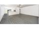 Spacious living room with grey wood-look flooring and ceiling fan at 3743 Bergamot St, Lake Alfred, FL 33850