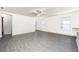Bright living room with grey wood-look flooring and ceiling fan at 3743 Bergamot St, Lake Alfred, FL 33850