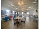 Clubhouse interior with tables, chairs, and a seating area with colorful furniture at 4552 Sequel Rd, Kissimmee, FL 34746
