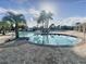 Community pool with palm trees and lounge chairs on a sunny day at 4552 Sequel Rd, Kissimmee, FL 34746