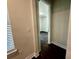 View into a bedroom from a hallway with dark floors at 7952 Wandering Way, Orlando, FL 32836