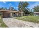 Ranch style home with brown garage door and stone accents at 3601 Deborah Dr # 3, Lakeland, FL 33810