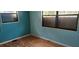 Small bedroom with teal walls and wood flooring at 242 Oak Hill Rd, Lady Lake, FL 32159