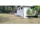 White house exterior with AC unit and partial foundation view at 242 Oak Hill Rd, Lady Lake, FL 32159