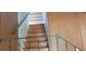 Wooden staircase with metal railing at 242 Oak Hill Rd, Lady Lake, FL 32159
