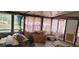 Sunroom with multiple windows and pink curtains at 242 Oak Hill Rd, Lady Lake, FL 32159