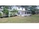 House with screened porch needing some TLC and a large backyard at 242 Oak Hill Rd, Lady Lake, FL 32159