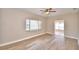 Living room with wood-look floors and window with blinds at 312 E Broadway, Fort Meade, FL 33841