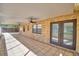 Spacious screened porch with tile floors, brick walls, and double doors at 312 E Broadway, Fort Meade, FL 33841