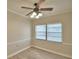 Dining room with ceiling fan, large windows, and light flooring at 312 E Broadway, Fort Meade, FL 33841