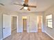 Spacious bedroom with ceiling fan, multiple closets, and window at 312 E Broadway, Fort Meade, FL 33841