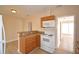 Updated kitchen with white appliances and wood cabinets at 312 E Broadway, Fort Meade, FL 33841