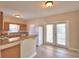 Kitchen with wood cabinets, breakfast bar, and French doors at 312 E Broadway, Fort Meade, FL 33841