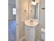 Clean bathroom with a white vanity, a large mirror, and updated fixtures at 312 E Broadway, Fort Meade, FL 33841
