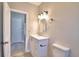 Bathroom with white vanity, toilet, and access to another room at 312 E Broadway, Fort Meade, FL 33841