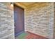 Brown front door entrance with brick wall and tile flooring at 312 E Broadway, Fort Meade, FL 33841