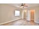 Bedroom with wood-look floors, window, and ceiling fan at 312 E Broadway, Fort Meade, FL 33841