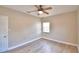 Bedroom with wood-look floors, window, and ceiling fan at 312 E Broadway, Fort Meade, FL 33841