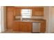 Kitchen features wood cabinets, double sink, and dishwasher at 312 E Broadway, Fort Meade, FL 33841