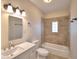 Updated bathroom with a tub, shower, and tile surround at 312 E Broadway, Fort Meade, FL 33841