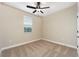 Bright bedroom with neutral walls, carpet flooring, and ceiling fan at 7737 Somersworth Dr, Kissimmee, FL 34747