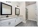 Modern bathroom with white cabinets, granite countertops, and a frameless shower at 7737 Somersworth Dr, Kissimmee, FL 34747