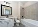 Bathroom with white vanity, granite countertop, and large tiled shower at 7737 Somersworth Dr, Kissimmee, FL 34747