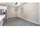Bright dining area with gray vinyl plank flooring and a modern chandelier at 7737 Somersworth Dr, Kissimmee, FL 34747