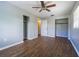 Spacious bedroom with dark wood-look floors and ceiling fan at 910 N Lincoln Ave, Lakeland, FL 33815
