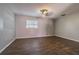Spacious bedroom with dark wood-look floors and ceiling fan at 910 N Lincoln Ave, Lakeland, FL 33815