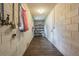 Long hallway with tile floor, storage shelving, and exterior door at 910 N Lincoln Ave, Lakeland, FL 33815