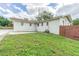 House exterior with grassy area and wooden fence at 910 N Lincoln Ave, Lakeland, FL 33815