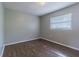 Simple bedroom with wood-look floors and a window at 910 N Lincoln Ave, Lakeland, FL 33815