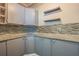 Corner kitchen with granite countertops and gray cabinets at 910 N Lincoln Ave, Lakeland, FL 33815