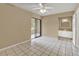 Bedroom with tile floors, sliding glass door, and ensuite bathroom at 1057 Old South Dr, Lakeland, FL 33811