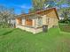 Side view of a single-story house with a grassy yard at 1057 Old South Dr, Lakeland, FL 33811