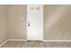 A simple entryway with a white door and tiled floor at 1057 Old South Dr, Lakeland, FL 33811