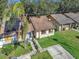 Aerial view of a tan house with a brown roof and solar panels at 1057 Old South Dr, Lakeland, FL 33811