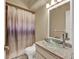 Bathroom with granite vanity, glass sink, and shower at 1057 Old South Dr, Lakeland, FL 33811