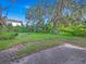 Large backyard with mature trees and grassy area at 1057 Old South Dr, Lakeland, FL 33811