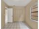 Simple bedroom with tile floors and a window at 1057 Old South Dr, Lakeland, FL 33811