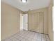 Bedroom with tile floors, a closet, and access to another room at 1057 Old South Dr, Lakeland, FL 33811