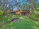 Large backyard featuring two structures and a fire pit area at 1057 Old South Dr, Lakeland, FL 33811