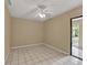 Bedroom with tile floors, ceiling fan, and sliding glass door at 1057 Old South Dr, Lakeland, FL 33811