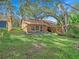 Spacious backyard with mature trees and a detached structure at 1057 Old South Dr, Lakeland, FL 33811