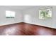 Spacious bedroom with hardwood floors and large windows at 554 Fairways Cir # A, Ocala, FL 34472