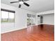 Living room with wood-look floors, ceiling fan, and patio access at 554 Fairways Cir # A, Ocala, FL 34472