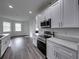 Modern kitchen with stainless steel appliances and gray countertops at 232 Samantha Ave, Auburndale, FL 33823