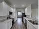 Modern kitchen with stainless steel appliances and light gray countertops at 232 Samantha Ave, Auburndale, FL 33823
